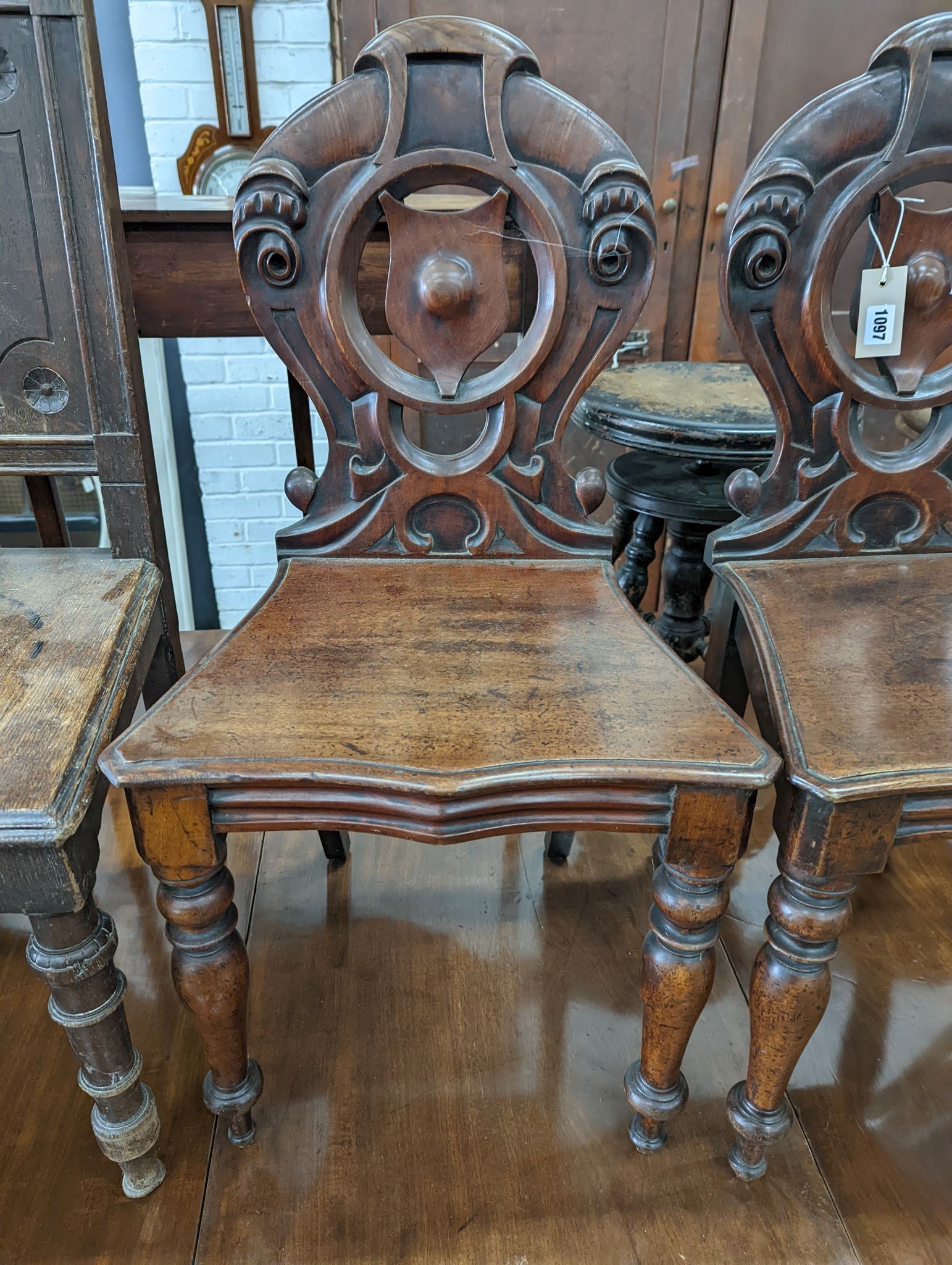 A pair of Victorian mahogany hall chairs and an oak hall chair